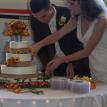 A bride and groom cut their beautifully decorated cake.